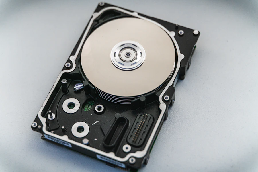 An opened hard drive showing its platter and read arm
