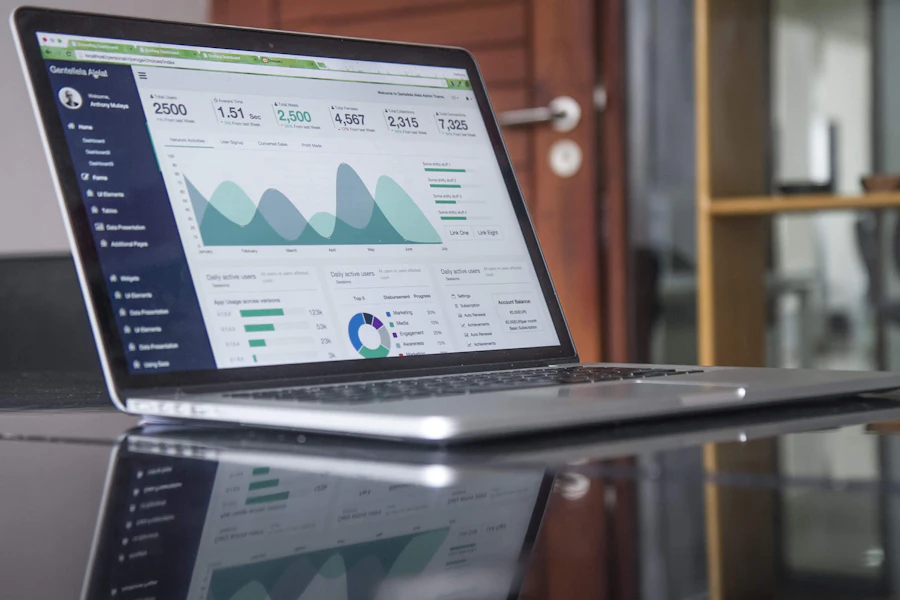 A laptop displaying an analytics dashboard with traffic charts