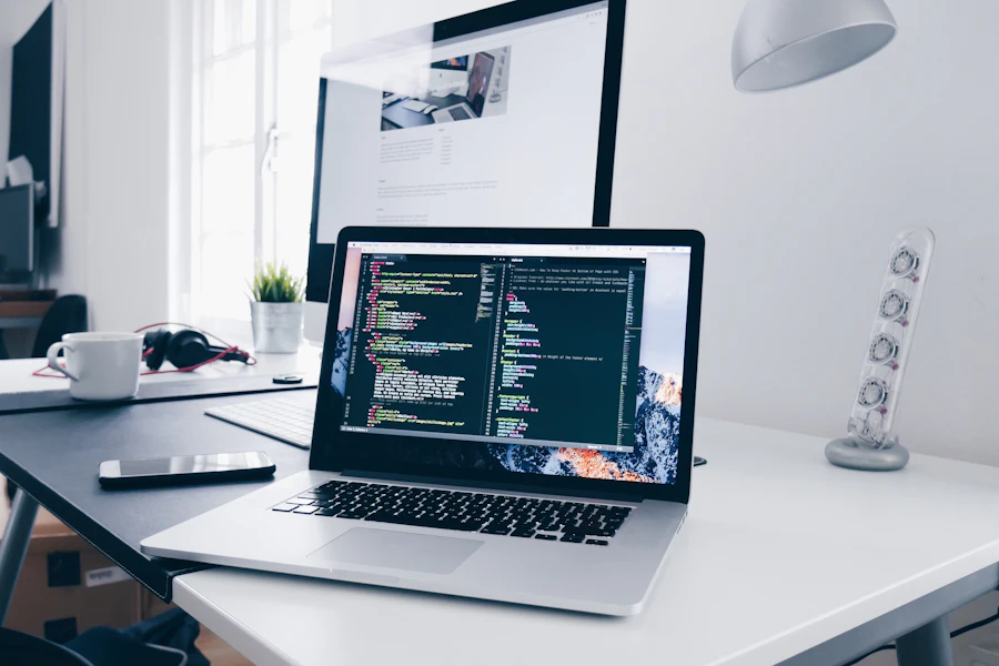 A laptop on a bright desk showing a code editor